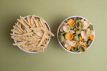 Pasta in a bowls on color background. Different types of pasta and noodles. Italian cuisine...