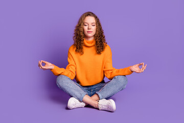 Full size photo of nice young girl sit floor meditate wear pullover isolated on violet color background