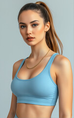Fototapeta premium Confident Woman in Light Blue Sports Attire with Determined Gaze, Fitness Promo with Plain Background