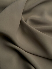 Beautiful folds of beige fabric. High-quality texture of beige fabric.