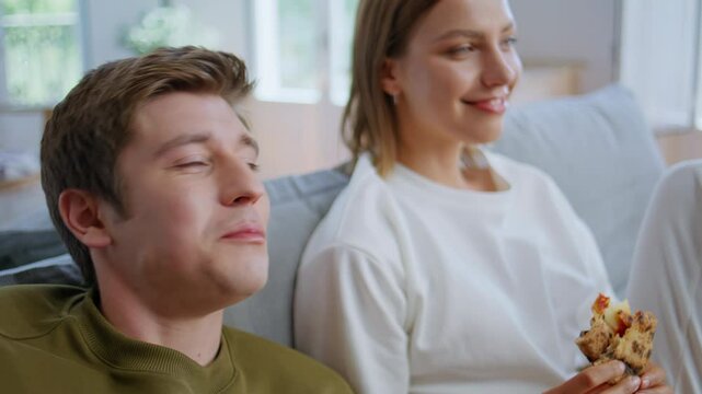 Eating youngsters giving five resting sofa closeup. Boyfriend girlfriend talking