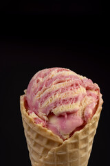 waffle cone with ice cream and pieces of melon and watermelon