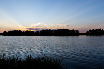 beautiful bright sunset on the lake in the summer