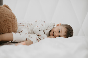 Joyful Boy Cuddling with Teddy Bear