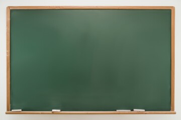 Blank Chalkboard: A classic green chalkboard with a wooden frame, ready for your message.  Perfect for education, classroom, school, teaching, learning,  knowledge, creativity, ideas,  presentation.
