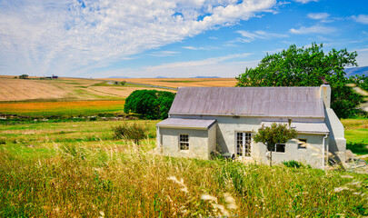 Close-up of a farmhouse with vast wheat farms in Caledon, Overberg, Western Cape, South Africa