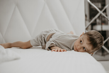 Resting Boy on White Bed