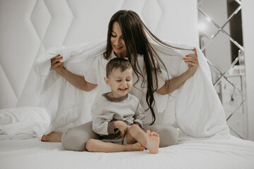 Cozy Mother and Child Moment Under Blanket