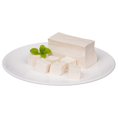 Blocks of tofu with some diced tofu on a white plate isolated transparent