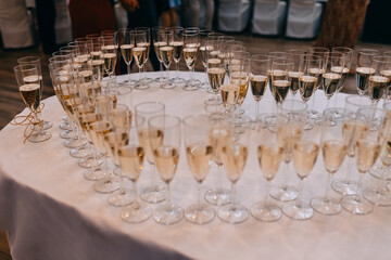 Champagne glasses arranged in heart shape during the wedding