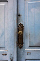 old blue wooden door with brass handle in the city of Braganca Paulista in the state of São Paulo,...