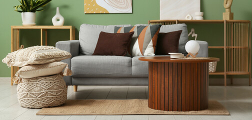 Grey sofa with soft cushions in stylish living room