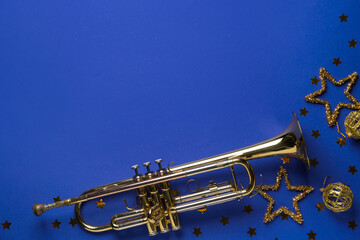Trumpet with Christmas decorations on purple background
