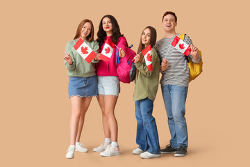 Fototapeta premium Group of students with flags of Canada on brown background