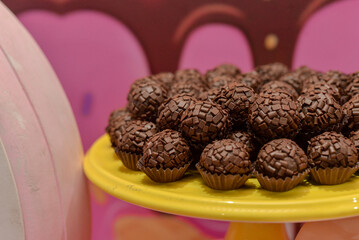 close up of candy, chocolate candies on a plate, brigadeiro, chocolate brigadeiro, sweet, brigadeiro tray, candy tray, party sweets, brazilian sweetie

