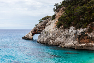 Naklejka premium Cala Goloritze. Amazing crystal clear Tyrrhenian sea at the eastern coast of Sardinia, Italy. Turquoise emerald water and gorgeous cliffs in Baunei area, Sardinia.