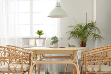 Interior of modern dining room with table and chairs