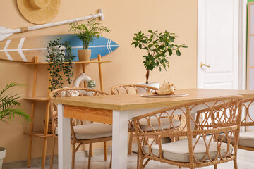 Interior of dining room with table and surfboard