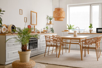 Stylish interior of modern kitchen with dining table and chairs