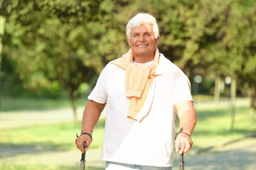 Mature man with walking poles in park, closeup
