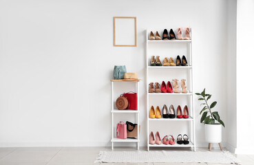 Interior of light room with shelf units, female shoes and bags