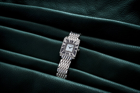 Cartier watch, Obus model. Quartz watch in 18 kt white gold on a dark background. Milan, Italy August 20, 2024