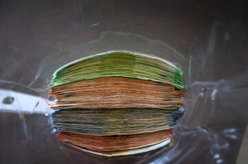 Lot of bank notes of different value in transparent plastic bag