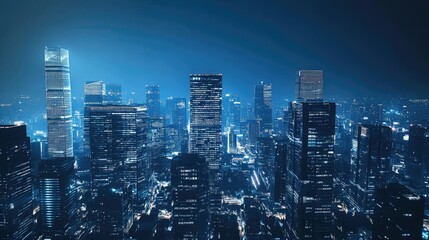 Obraz premium A panoramic view of a city skyline at night, illuminated by bright lights.