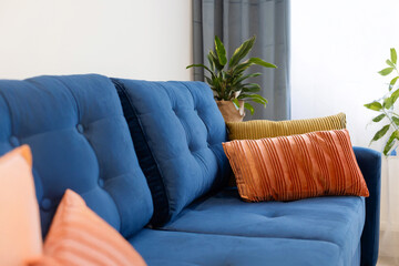  Colorful pillows on a navy blue sofa, apartment decor, new apartment, renovation, home decoration © Katarzyna Ledwoń