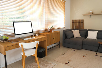 Workplace with computer in interior of living room