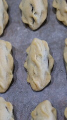 raditional Moroccan Mooncakes with Intricate Floral Pattern on Baking Sheet – Close-Up of Handmade Festival Cakes, Authentic Pastry Design, and Cultural Delicacies for Special Occasions