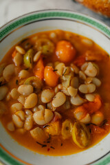vegetarian bean soup in bowl with green greek key