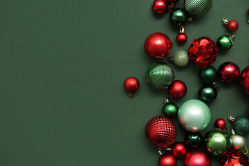 Composition with different Christmas balls on green background