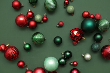 Composition with different Christmas balls on green background