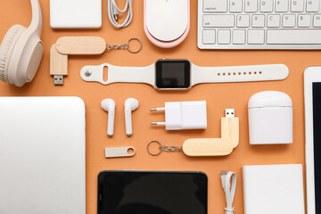 Composition with various modern gadgets on color background