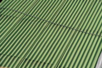 Close up of green corrugated metal roof. Detail f Corrugated green roof Background with a...