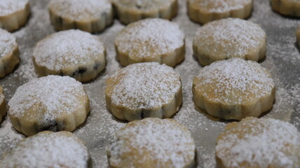 raditional Moroccan Mooncakes with Intricate Floral Pattern on Baking Sheet – Close-Up of Handmade Festival Cakes, Authentic Pastry Design, and Cultural Delicacies for Special Occasions