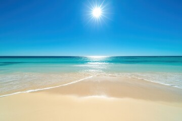 Obraz premium A serene beach scene with clear blue water and a bright sun overhead.