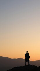 a man standing on a mountain top at sunset