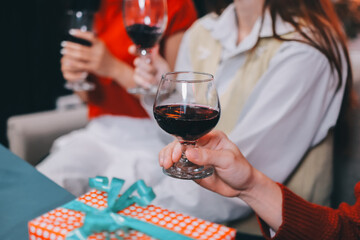Friends opening Christmas gifts in living room