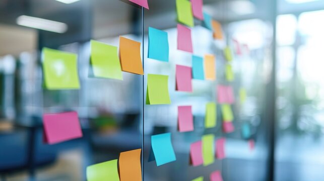 Colorful Post it notes on a glass board professionals engaging with reminders during a team meeting in a conference room emphasizing collaboration and teamwork