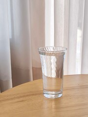 Drinking water on wooden table. Refreshment and hydrate concept