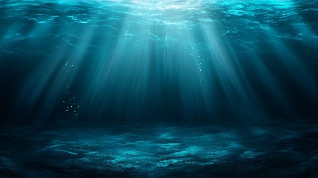 A close-up underwater shot of light beams shining down on a dark seabed with a few bubbles floating up.