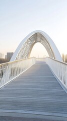 Obraz premium A modern white arch bridge spans a pathway, inviting pedestrians to cross.