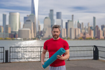 Senior man in fitness wear workout in NYC. Healthy retirement lifestyle. Active senior man is exercising outdoor. Active after retirement. Mature retired sportsman doing stretching exercises.