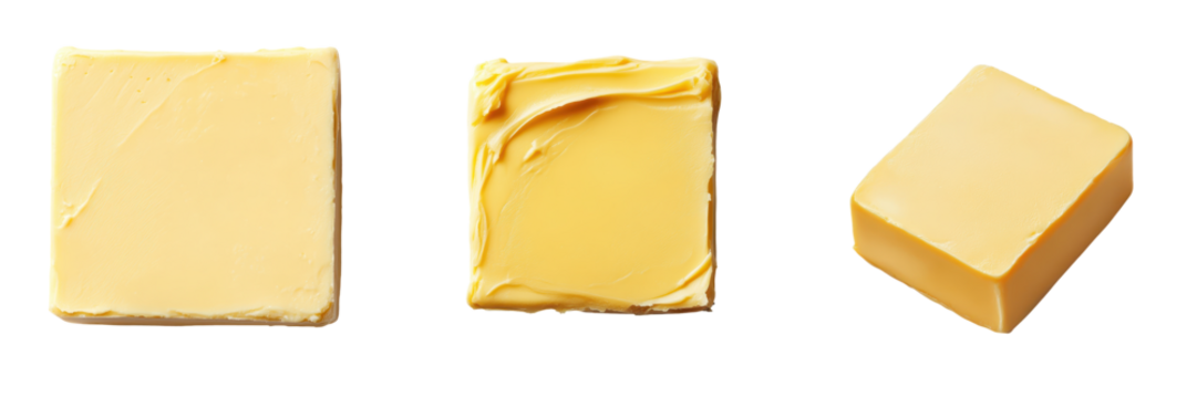 Close up view of various blocks and slabs of butter against a plain white background  This image is perfect for culinary and cooking related content showcasing the rich