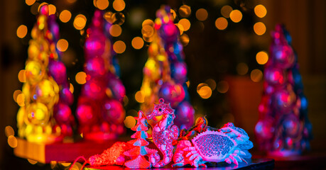 New Years, Christmas card. Christmas tree with night bokeh background. Christmas pine tree. Christmas sea decorations for the new year. New Year background with Seahorse and shells. © Volodymyr