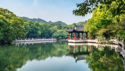 Naklejka premium Traditional Chinese Pavilions in Hangzhou’s West Lake Surrounded by Lush Gardens and Reflective Waters, Creating a Serene Cultural Landscape Perfect for Peaceful Meditation and Photography
