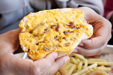 Indulge in a Delicious Cheesy Burger topped with Crispy Bacon and served with Fries on the side