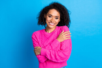 Fototapeta premium Photo portrait of attractive young woman hug self enjoy warmth dressed stylish pink clothes isolated on blue color background